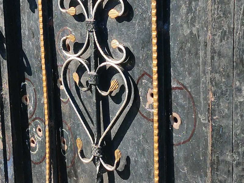 Bullet holes in the door of one of the targeted houses in Dhangri village | Photo: Amogh Rohmetra | ThePrint