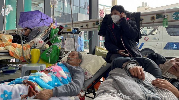 Patients lie on beds in the emergency department of a hospital, on 5 January 2023 | Reuters