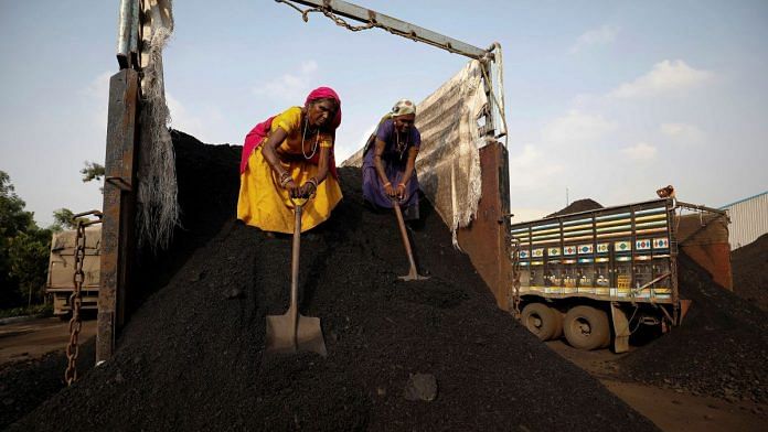 Workers unload coal from a supply truck at a yard on the outskirts of Ahmedabad | Reuters file photo