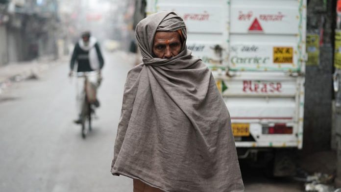 A man wraps himself in warm cloth during a cold winter morning in New Delhi, on 4 Jan 2022 | ANI photo