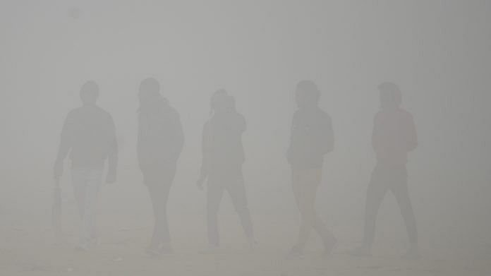 Pedestrians walk on a road amid dense fog on a cold winter morning, on 8 January 2023 | ANI photo