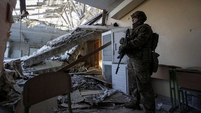 A Ukrainian serviceman is seen in a destroyed building of a school at a frontline, amid Russia's attack on Ukraine, in Donetsk region, Ukraine 7 January 2023 | Reuters/Anna Kudriavtseva