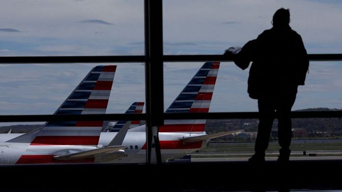 American Airlines aircraft are seen while a passenger waits for boarding at the Reagan International Airport in Washington, US | Reuters/Carlos Barria/File Photo