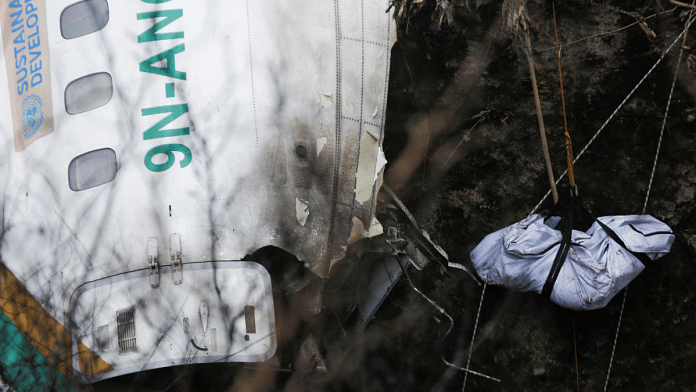 A rescue team recovers the body of a victim from the site of the plane crash of a Yeti Airlines operated aircraft, in Pokhara, Nepal | Reuters Photo/Rohit Giri