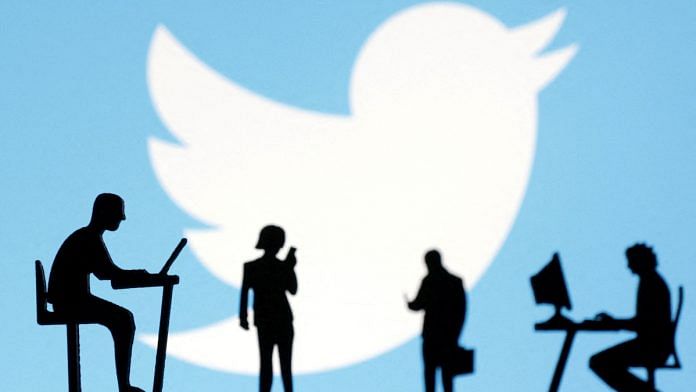 Figurines with smartphones and computers are seen in front of the Twitter logo in this illustration | Reuters
