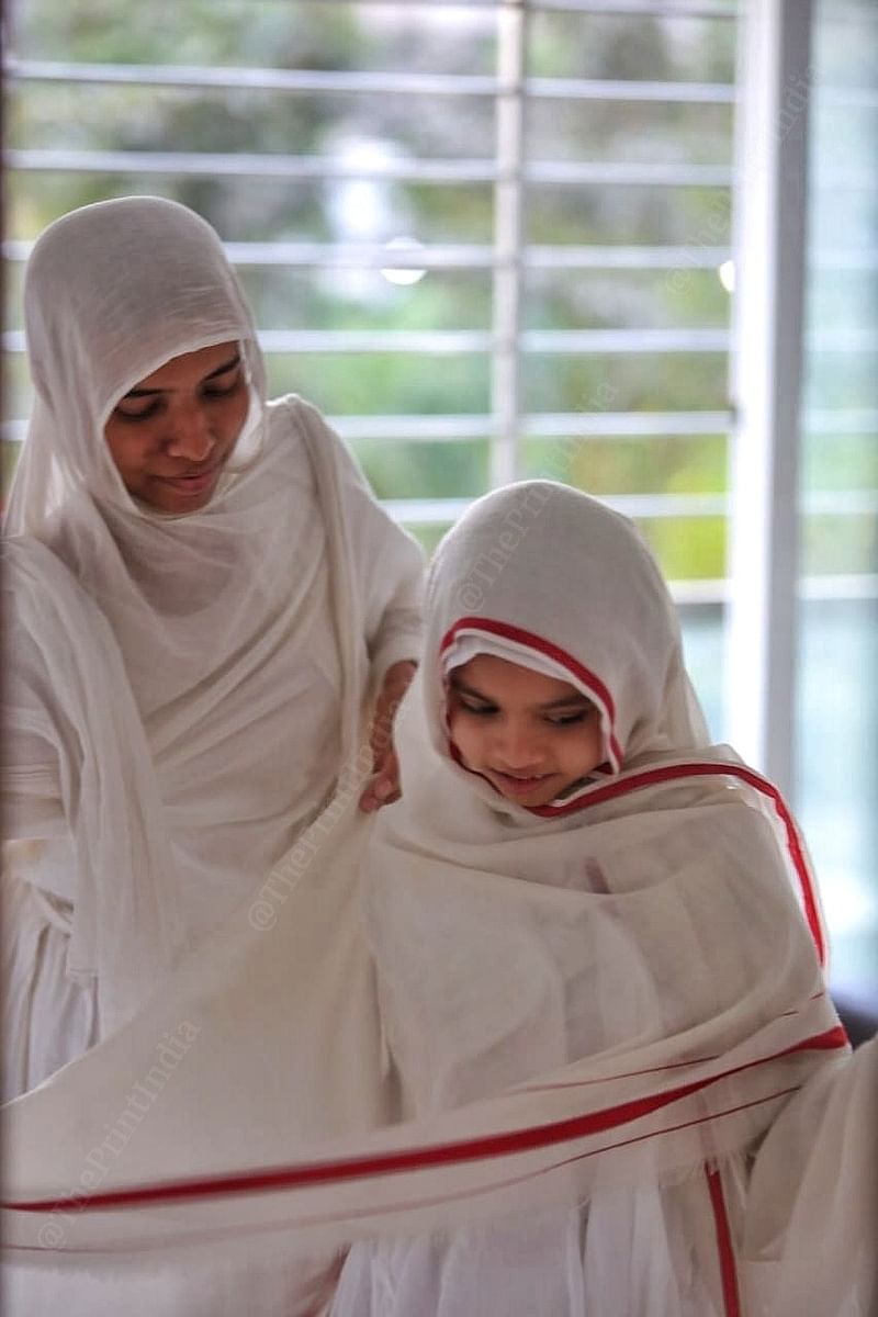 A senior sadhvi helps Sadhvi Pragya Shriji get dressed in plain white robes | Praveen Jain | ThePrint