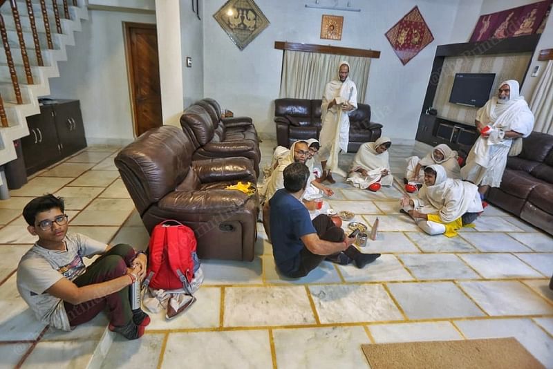 Varsham Jain (on the left) sits on the side as monks rest at the house of a devotee. The 16-year old is undergoing training to see if he’s suited to become a monk | Praveen Jain | ThePrint