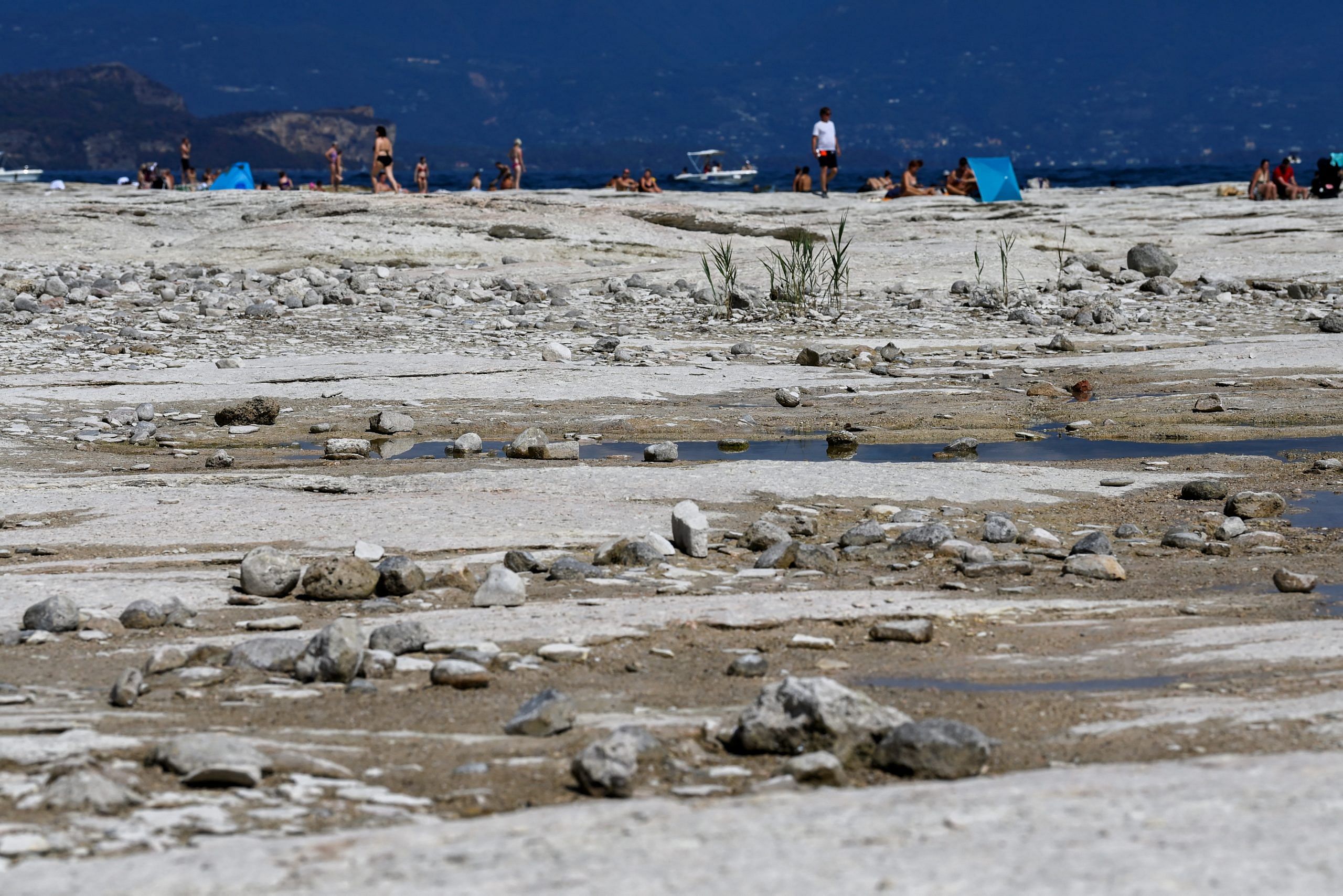 File photo: Underwater rocks emerge from the water of Lake Garda after northern Italy experienced the worst drought in 70 years in Sirmione, Italy | Reuters | Flavio Lo Scalzo