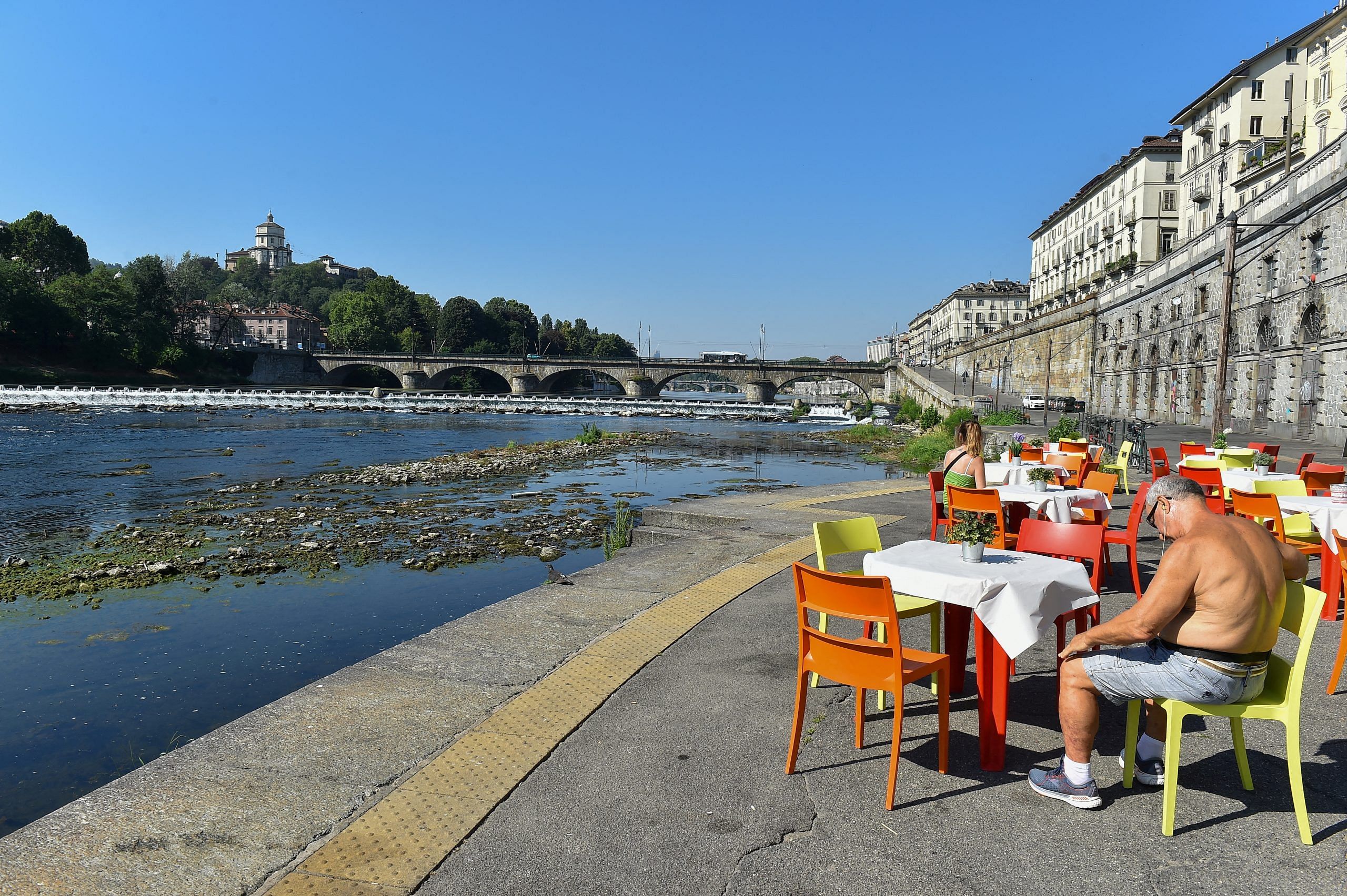 File photo: A view shows restaurant tables next to Po's dry riverbed, as parts of Italy's longest river have dried up due to the worst drought in the last 70 years, in Turin, Italy | Reuters | Massimo Pinca