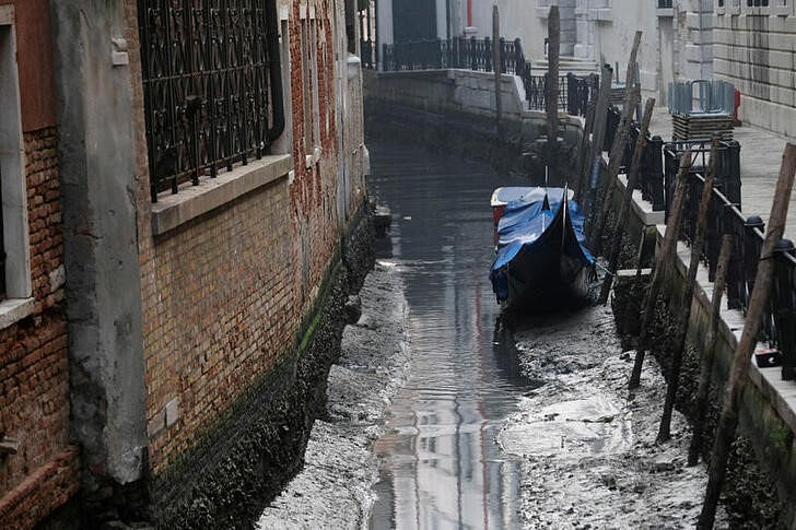 A gondola is pictured in a canal during a severe low tide in the lagoon city of Venice, Italy | Reuters | Manuel Silvestri 