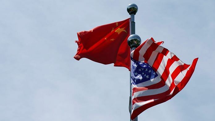 FILE PHOTO: Chinese and U.S. flags flutter near The Bund, before U.S. trade delegation meet their Chinese counterparts for talks in Shanghai, China July 30, 2019. REUTERS/Aly Song