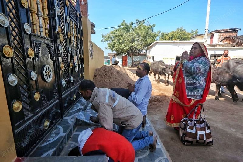 Followers pray outside Baba's house where he was born and his parents still live. They come to catch a glimpse of Baba's parents | Photo: Praveen Jain | ThePrint