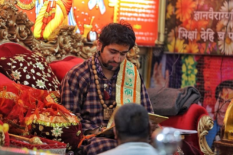 Baba Dhirendra Krishna Shastri sits surrounded by his followers | Photo: Praveen Jain | ThePrint