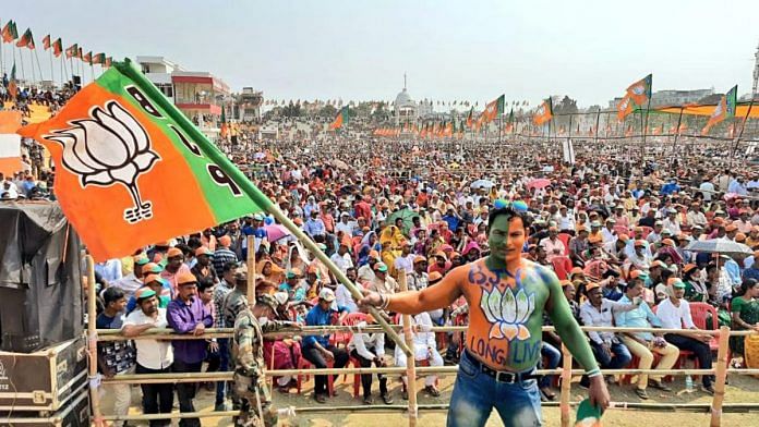 A BJP supporter waves the party flag at a rally | Representational image | ANI A BJP supporter waves the party flag at a rally | Representational image | ANI