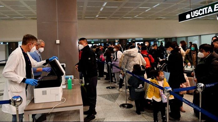 Passengers wait in a queue, after Italy has ordered Covid-19 antigen swabs and virus sequencing for all travellers coming from China, where cases are surging, at the Malpensa Airport in Milan, Italy, on 29 December, 2022 | Reuters