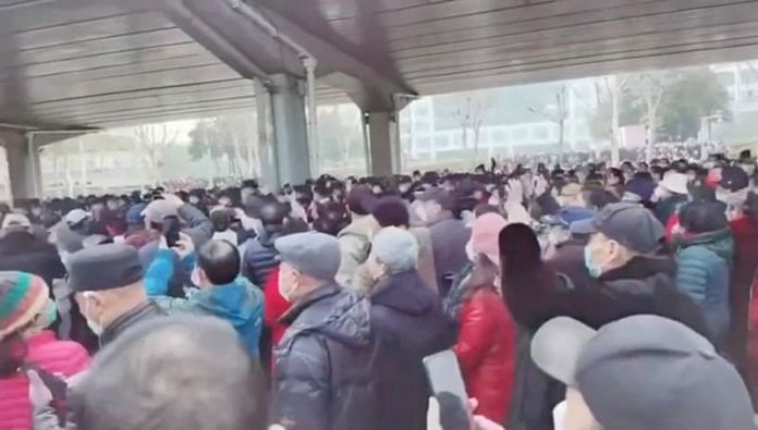Demonstrators gather outside Zhongshan park to protest changes to medical benefits in Wuhan, China on 15 February, 2023 in this still image from social media video obtained by Reuters