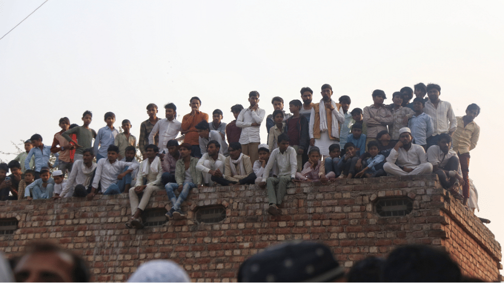 Villagers gathered outside homes of Junaid, Nasir in Ghatmika village | Manisha Mondal | ThePrint