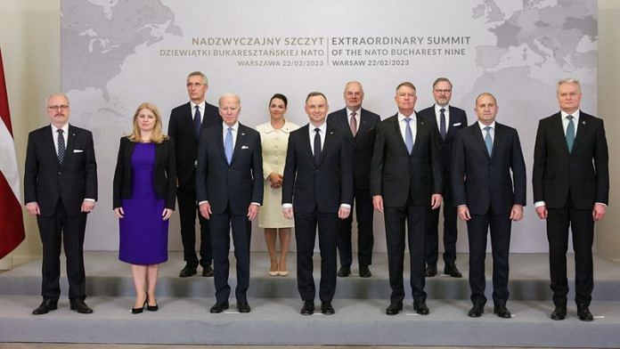 U.S. President Joe Biden and NATO Secretary-General Jens Stoltenberg alongside Romania's President Klaus Iohannis, Slovakia's President Zuzana Caputova, Poland's President Andrzej Duda and others pose for a group photo during the NATO Bucharest Nine (B9) Summit, during Biden's visit to Poland to mark the first anniversary of Russia's invasion of Ukraine, at the Presidential Palace in Warsaw, Poland on 22 February, 2023 | Reuters