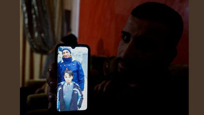 A relative of a Palestinian man, Abdel-Karim Abu Jalhoum, who died with his family in the earthquake in Turkey, shows his picture on a phone, at the family house in Beit Lahiya in northern Gaza Strip 8 February 2023 | Reuters/Mohammed Salem