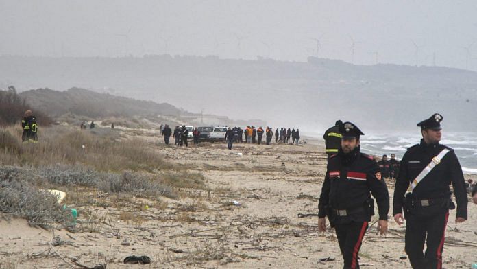 Carabinieri officers work at the beach where bodies believed to be of refugees were found after a shipwreck in Cutro, Italy, on 26 February 2023 | Reuters