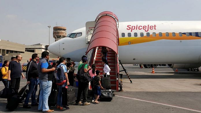 Passengers board a SpiceJet Boeing 737-800 airplane, previously operated by Jet Airways, at an airport in New Delhi, India June 9, 2019. REUTERS/Danish Siddiqui