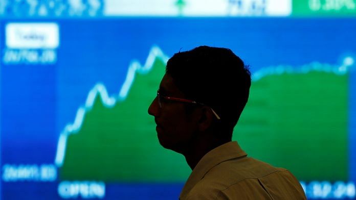 A man looks at a screen displaying news of markets update inside the Bombay Stock Exchange (BSE) building in Mumbai | Reuters file photo