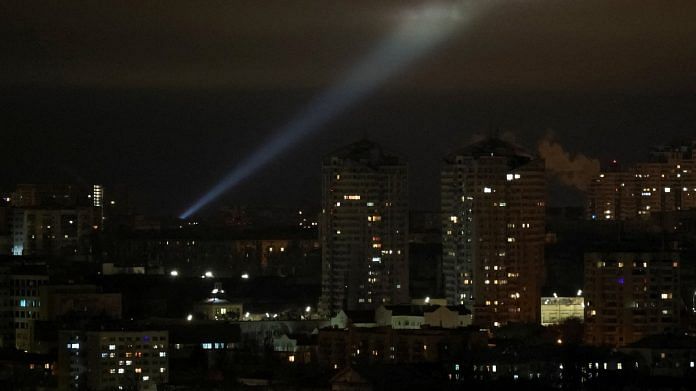 Ukrainian servicemen use a searchlight as they search for drones in the sky over the city during a Russian drone strike in Kyiv, on 27 February 2023 | Reuters