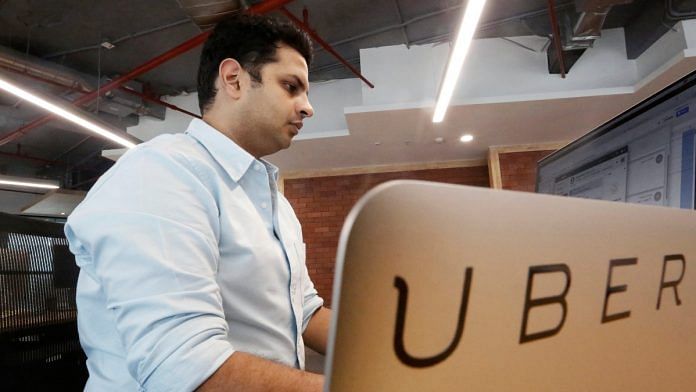 An employee works inside the office of ride-hailing service Uber in Gurugram | Reuters file photo