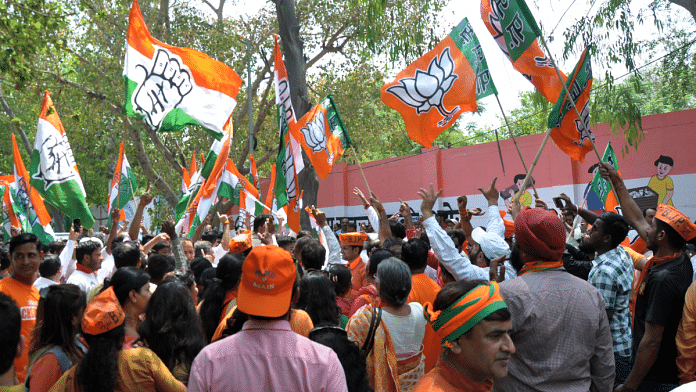 File photo of BJP, Congress workers with flags of their parties in Delhi | ANI