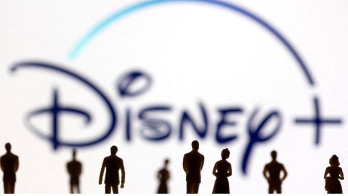 File photos of toy figures of people seen in front of the displayed Disney + logo, on 20 January, 2022 | Reuters