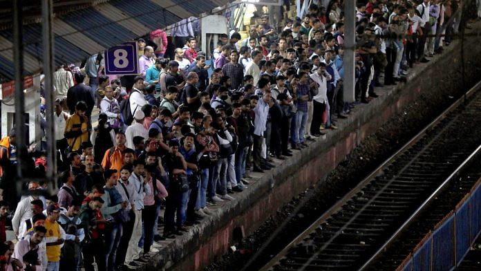 Commuters crowd on a platform as they wait to board suburban trains at a railway station in Mumbai, India, on 20 January, 2023 | Reuters