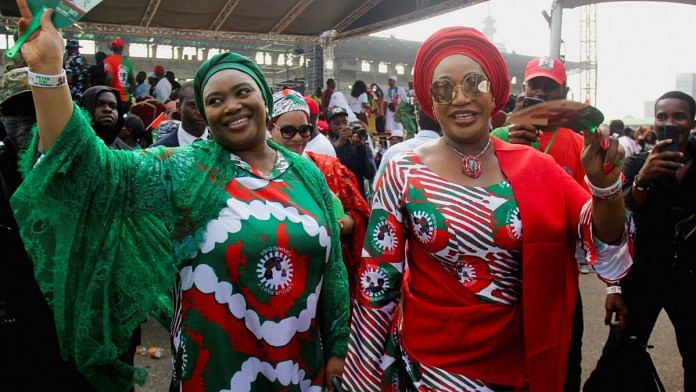 Margaret Obi, wife of Presidential candidate Peter Obi of Labour Party (LP), and Hajiya Aisha Baba-Ahmed, wife of Vice Presidential candidate Yusuf Datti Baba-Ahmed, wear traditional attires with LP branding during a campaign rally in Lagos, Nigeria on 11 February, 2023 | Reuters