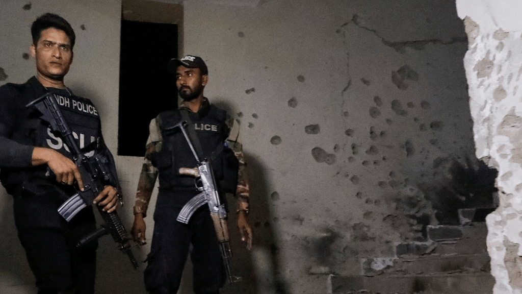 Police officers stand in the aftermath of an attack on a police station in Karachi, Pakistan 17 February, 2023 | Reuters/Akhtar Soomro