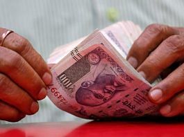 A man counts Indian currency notes inside a shop in Mumbai, India, August 13, 2018 | Reuters