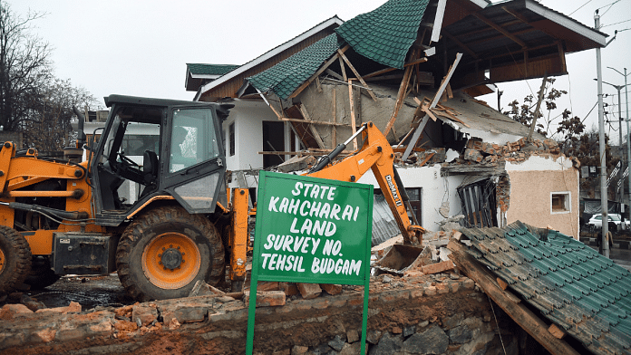File photo of a JCB machine demolishing residence of senior Jammu and Kashmir National Conference (JKNC) leader Ali Mohammad Sagar near Srinagar Airport | ANI