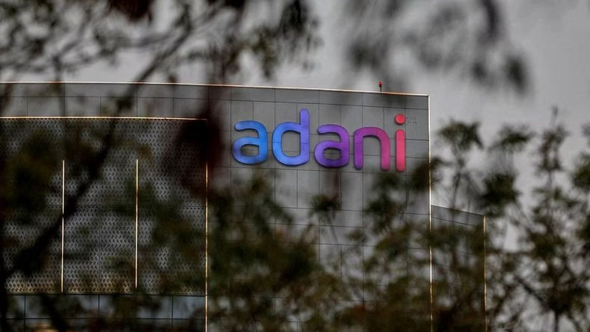 File photo of the logo of the Adani Group as seen on the wall of its realty office building on the outskirts of Ahmedabad, India, on 27 January, 2023 | Reuters