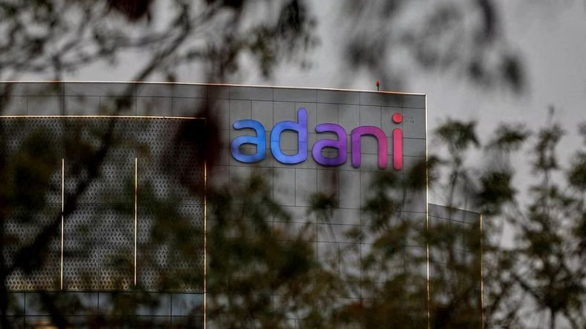 Untitled design (99) File photo of the logo of the Adani Group as seen on the wall of its realty office building on the outskirts of Ahmedabad, India, on 27 January, 2023 | Reuters