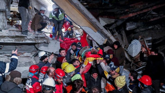 Rescuers carry out a person from the rubble, as the search for survivors continues, in the aftermath of a deadly earthquake, in Hatay, Turkey, on 10 February 2023 | Reuters