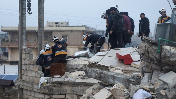 Rescuers search for survivors under the rubble of a damaged building, following an earthquake, in rebel-held Azaz, Syria, Monday | REUTERS/Mahmoud Hassano