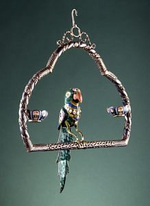 Parrot on a Swing, Varanasi, Uttar Pradesh, India, Late 19th century, Enameled silver inlaid with foil-backed glass set in gold; parcel-gilt silver repoussé. Image courtesy of the Los Angeles County Museum of Art.