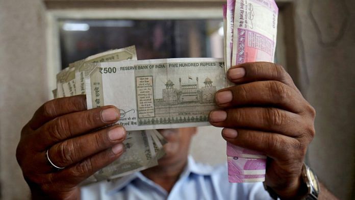 A cashier checks Indian rupee notes inside a room at a fuel station in Ahmedabad | Representational image | Reuters file photo