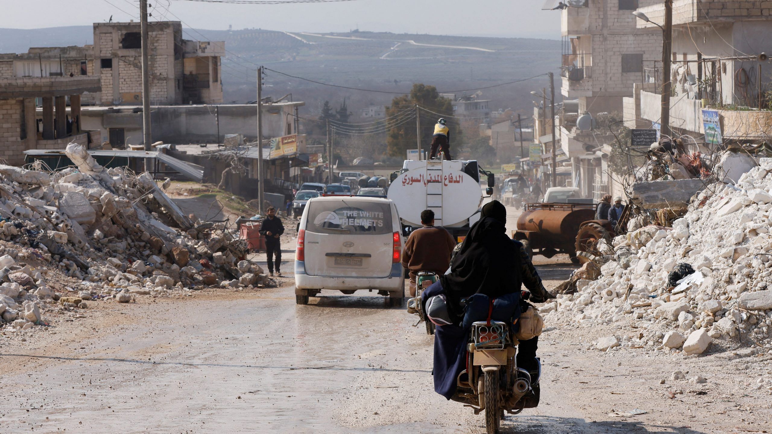 People drive through a demolished street in the aftermath of an earthquake in the rebel-held town of Harem, in Idlib governorate, Syria on 14 February 2023 | Photo: Reuteus