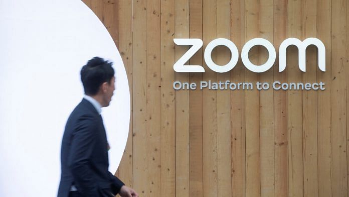 A man walks past a temporary show room of Zoom during the 2023 World Economic Forum in the Alpine resort of Davos, Switzerland | Reuters