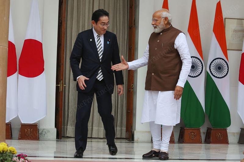 PM Modi holds out his hand to Kishida, as the Japanese PM smiles warmly | Photo: Praveen Jain | ThePrint