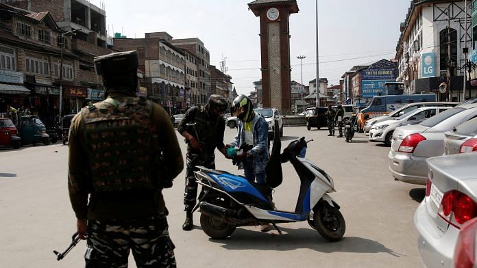 Indian CRPF personnel check the bags of a scooterist as part of security checking in Srinagar | File Photo: Reuters
