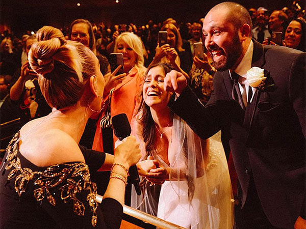 Adele signs a bride's wedding dress during her Las Vegas Residency Show