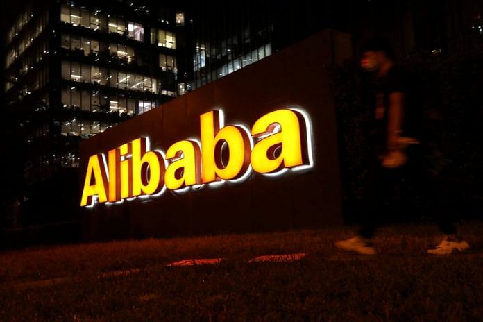 A man walks past a logo of Alibaba Group at its office building in Beijing, China | Reuters file photo