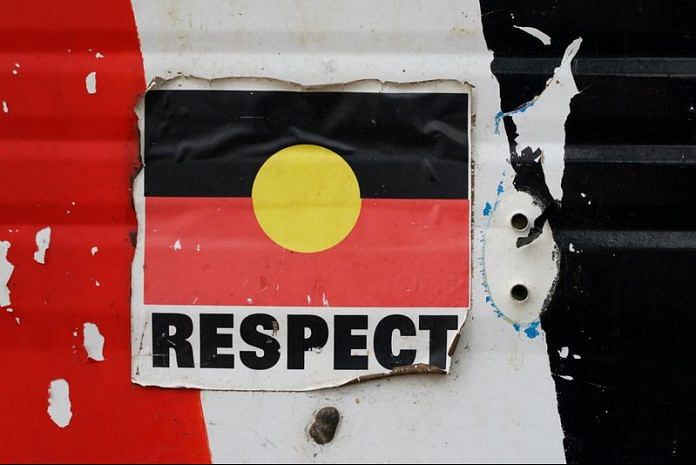 A sticker of the Australian Aboriginal Flag along with the word 