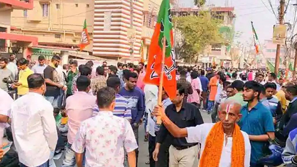BJP workers gather outside the party office during counting of votes for Tripura assembly elections in Agartala on Thursday | Photo: PTI