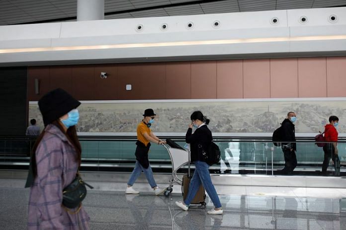 Passengers wearing face masks following the coronavirus disease outbreak walk at the Beijing Daxing International Airport ahead of Chinese National Day holiday, in Beijing, 15 September, 2020 | Reuters/Carlos Garcia Rawlins